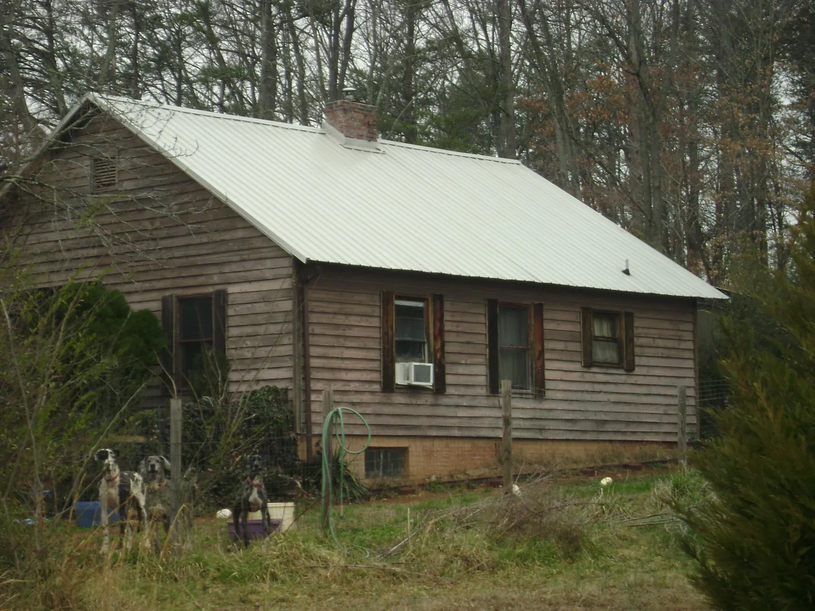 White metal roof on an old wood sided farmhouse, from a Metal Roof Installation job in Moreland